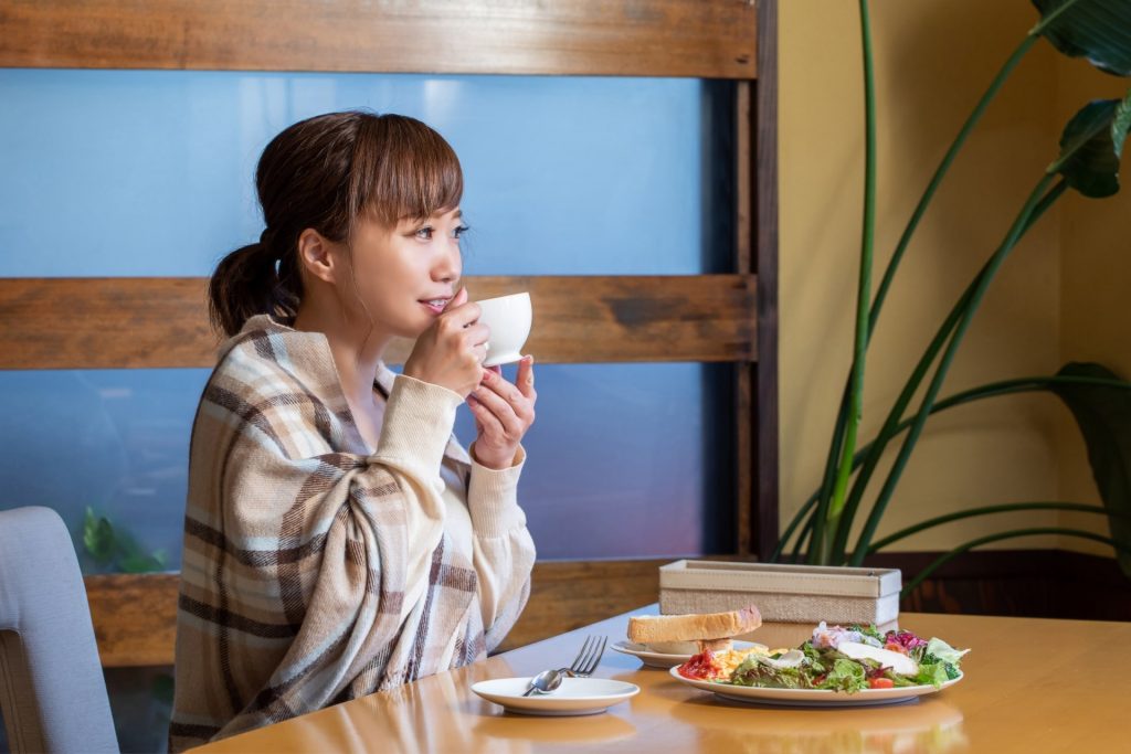 Japanese woman eating traditional breakfast
